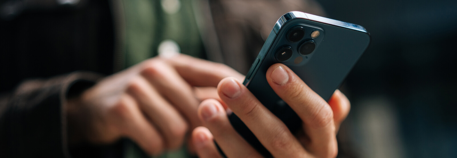 A close-up of hands holding a smartphone
